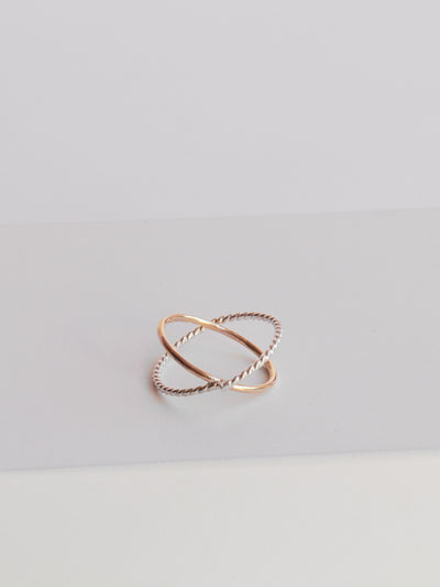 Gold and Silver Criss-Cross Twist/Smooth Ring. This orbital ring is made from high quality 14k yellow gold filled metal and twisted sterling silver. It makes a great standalone ring or stacker. Size 6.