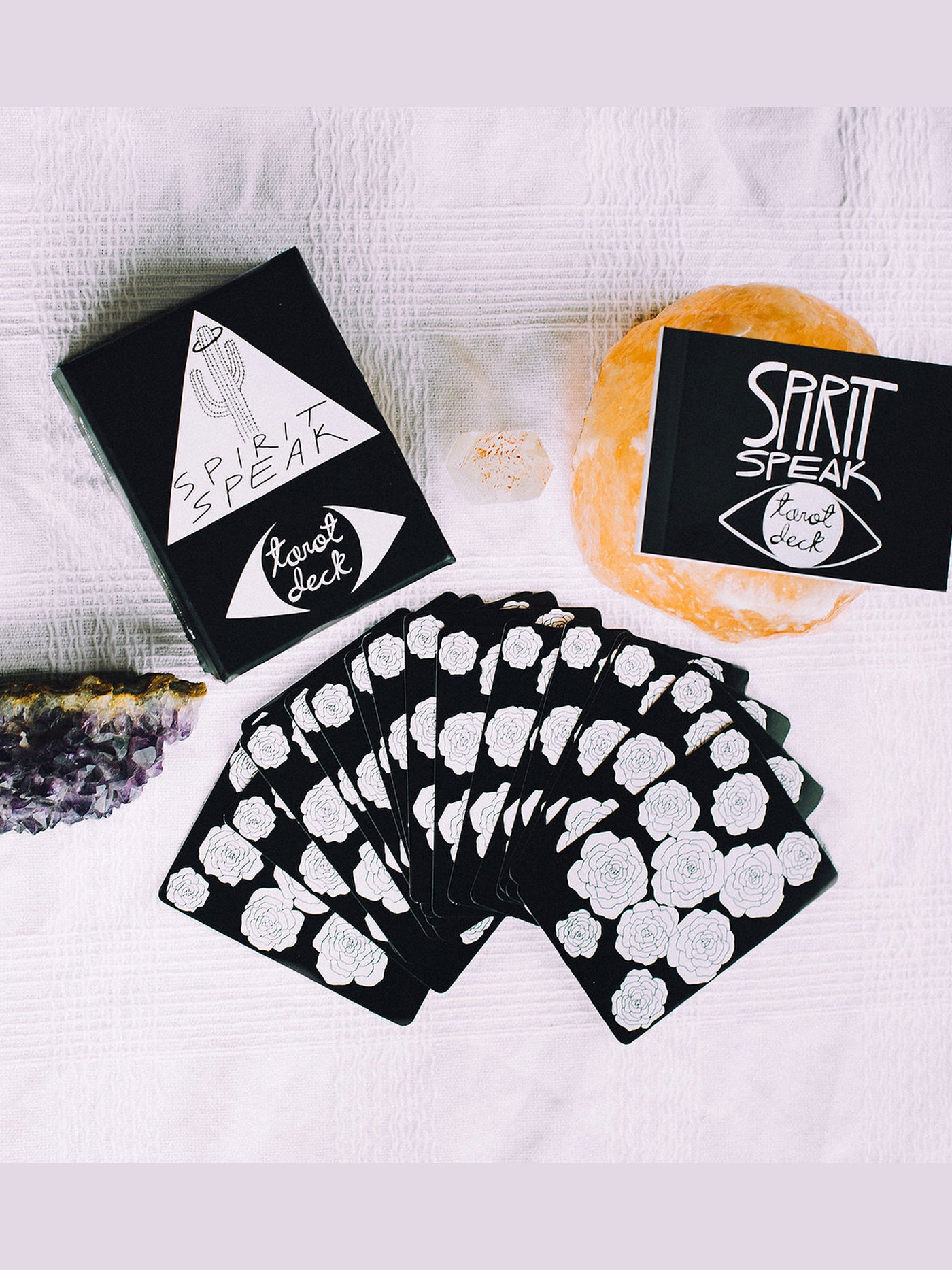 The Spirit Speak Tarot Deck is a 78 card hand drawn black and white tarot card deck. They are the size of traditional playing cards making them easy to toss in your bag. Each deck comes with a keepsake box and a small guidebook that explains each card meaning.