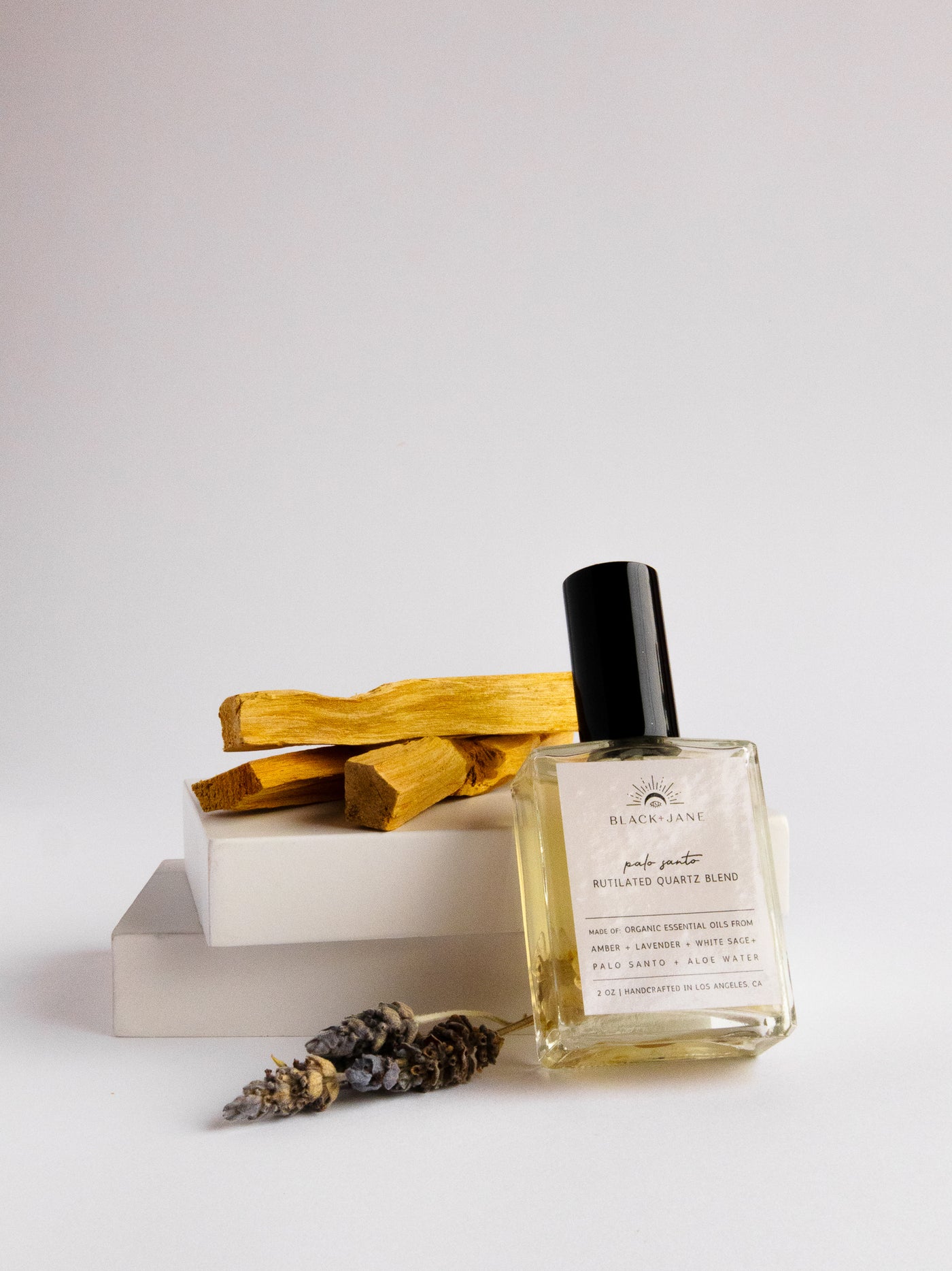 RUTILATED QUARTZ CRYSTAL INFUSED PALO SANTO ROOM + LINEN MIST with notes of rosewood, sage, nutmeg, rose, frankincense, and lemon.