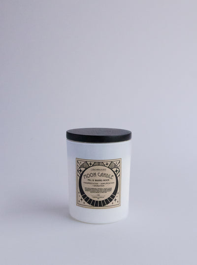 The Full & Waxing Moon Candle is made with 100% American soy and beeswax, with notes of wisteria, rose, and violet. Each candle comes topped with selenite, quartz crystal, roses, pine needles, and chamomile, and on the bottom once it is burned down you will find a quartz point for extra manifesting.