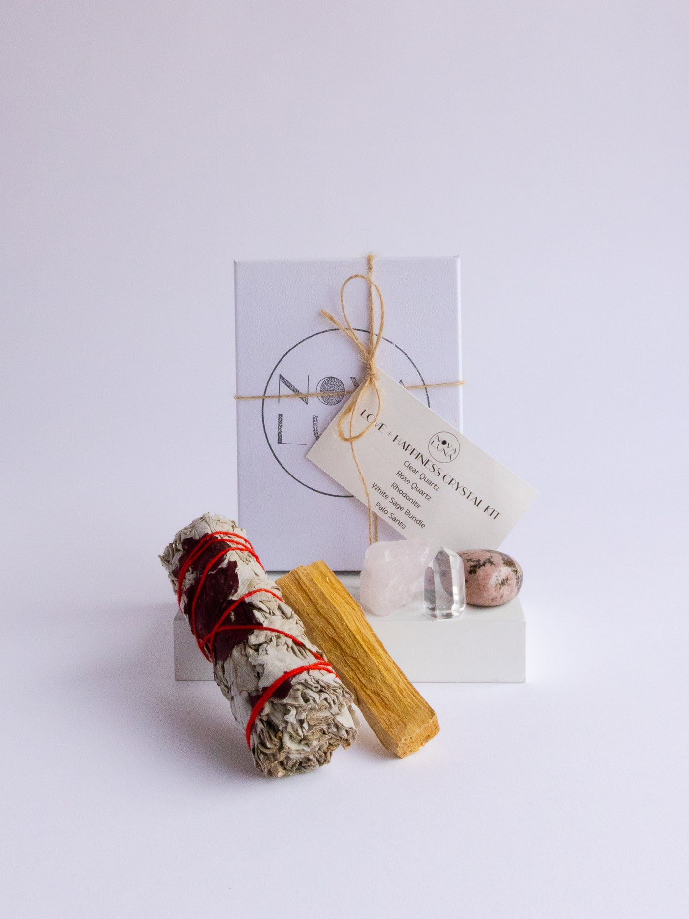 Love + Happiness Crystal Kit with Clear Quartz, Rose Quartz, Rhodonite, White Sage, and Palo Santo.
