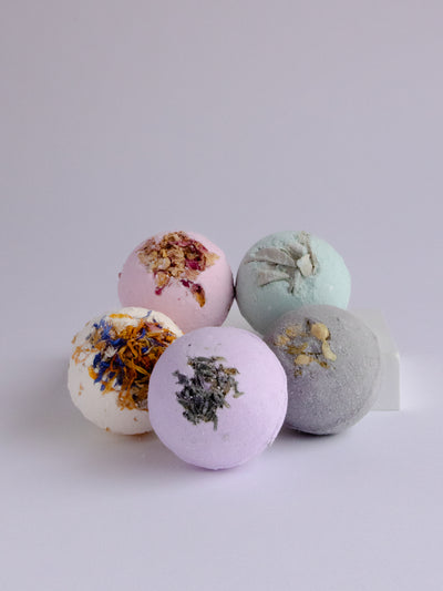 Jasmine Cole bath bomb is made with coconut oil, dried jasmine, and activated charcoal. Handmade in Ojai, CA.