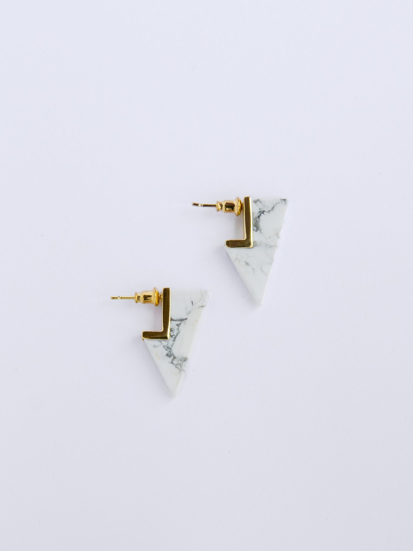 HOWLITE DAGGER STUDS. Howlite geometric and modern dagger studs are attached to stainless steel post with 24K gold overlay.