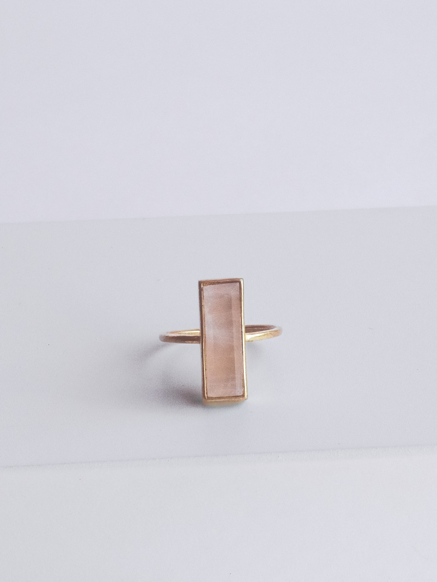ROSE QUARTZ GEM BAR RING is bezel-set in a recycled brass band with 24K gold overlay. Size 7.