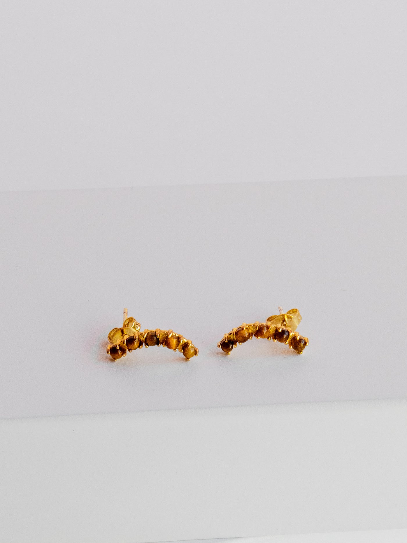GOLD TIGERS EYE PAVE CRAWLER STUDS. Made of recycled brass with 24K gold overlay. Attached to stainless steel post with 24K gold overlay.