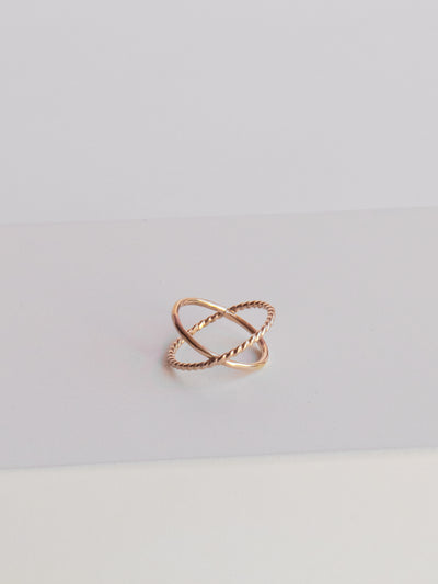 Gold Criss-Cross Twist/Smooth Ring. This orbital ring is made from high quality 14k yellow gold filled smooth and twisted metal. A size 3 makes a great stacker ring meant to be worn mid-finger.