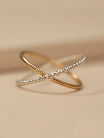 Gold and Silver Criss-Cross Twist/Smooth Ring. This orbital ring is made from high quality 14k yellow gold filled metal and twisted sterling silver. It makes a great standalone ring or stacker. Size 6.